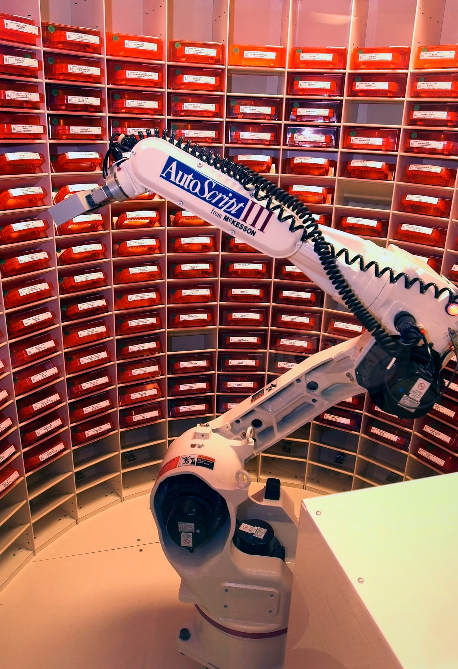 US Navy 030819-N-9593R-056 The Autoscript III, a prescription filling robot, picks up a bin of medication at the National Naval Medical Center in Bethesda, Maryland