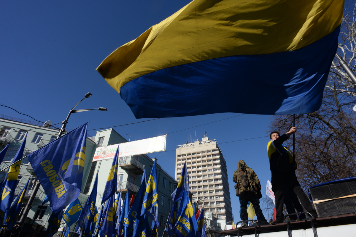 Proteser waving state flag of Ukraine expressing his support. Clashes in Kyiv, Ukraine. Events of February 18, 2014
